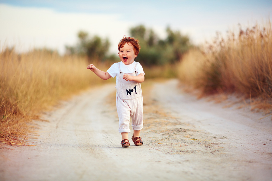 Little boy wearing beige minimalist overalls