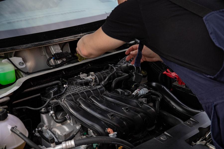 Man checking out a car’s engine