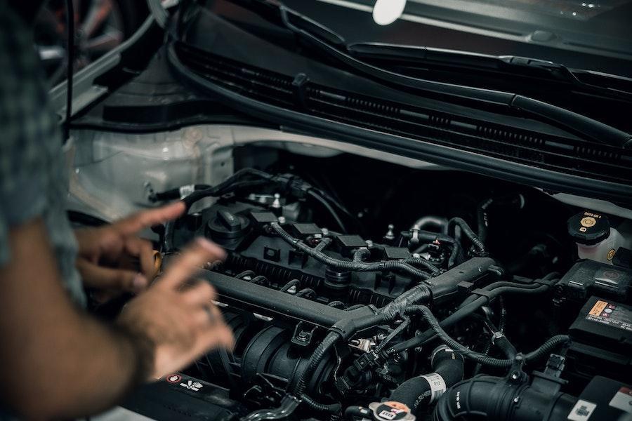 Man diagnosing a car engine