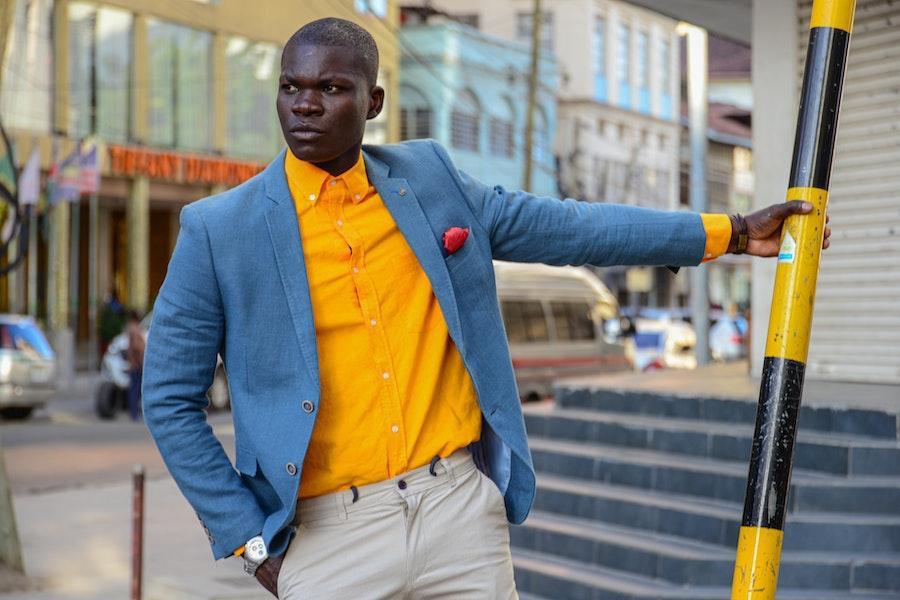 Man holding a pole with a light blue statement blazer