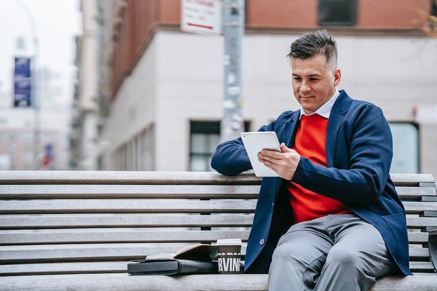 Man sitting on a bench with blue unstructured blazer