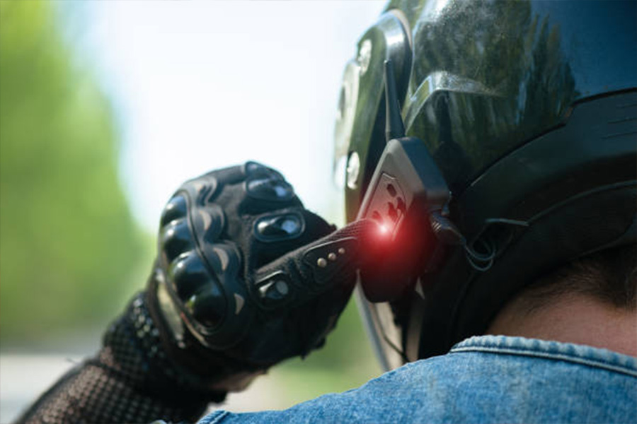 Motorcycle rider with intercom on the side of the helmet