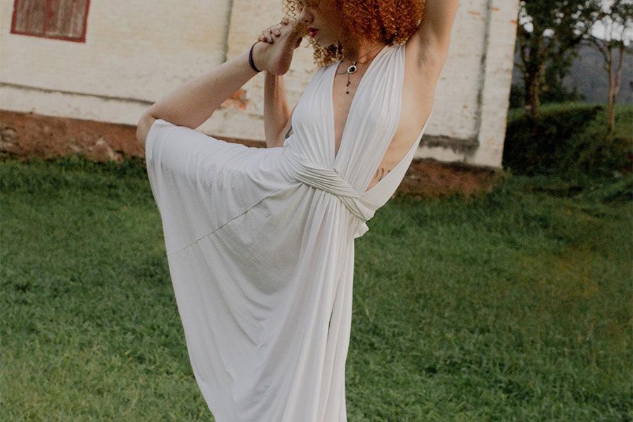 Woman striking a pose with a haltered dress