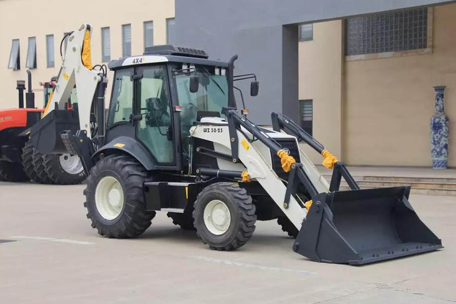 Backhoe excavator in front of a factory