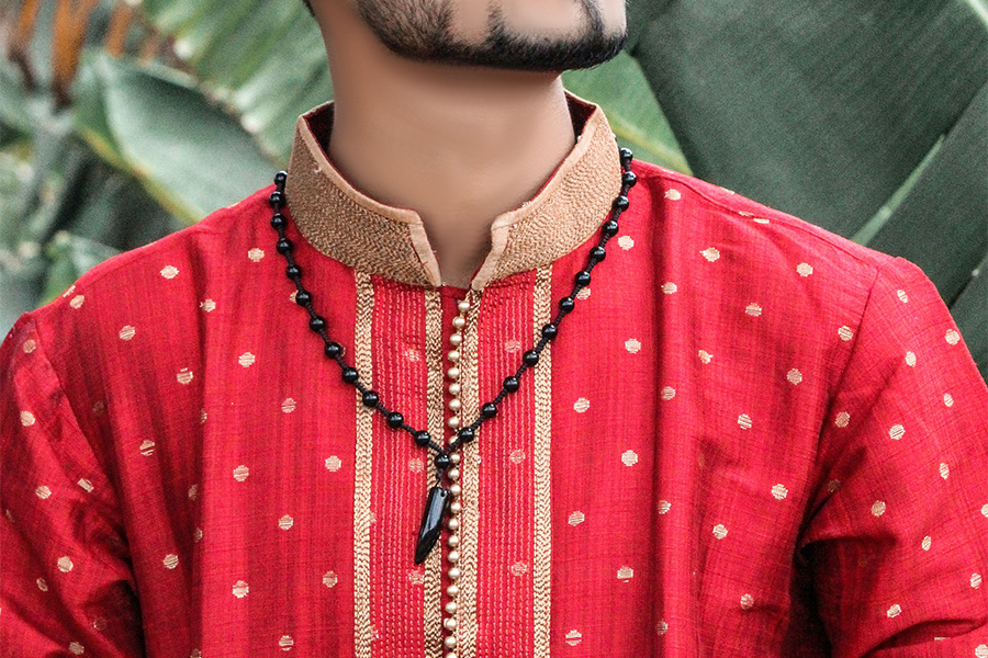 man in a red patterned shirt with a band collar