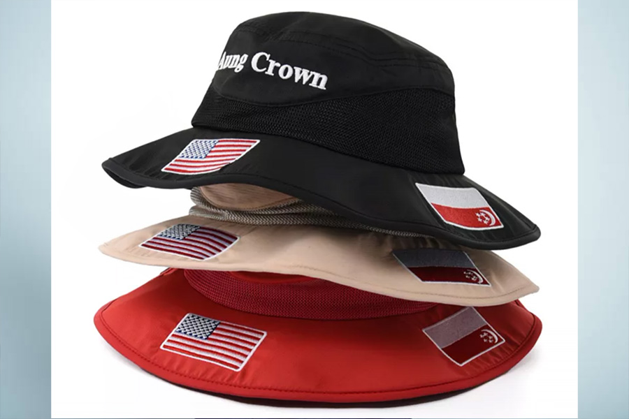 Three colors of bucket hats with stamps of flags on