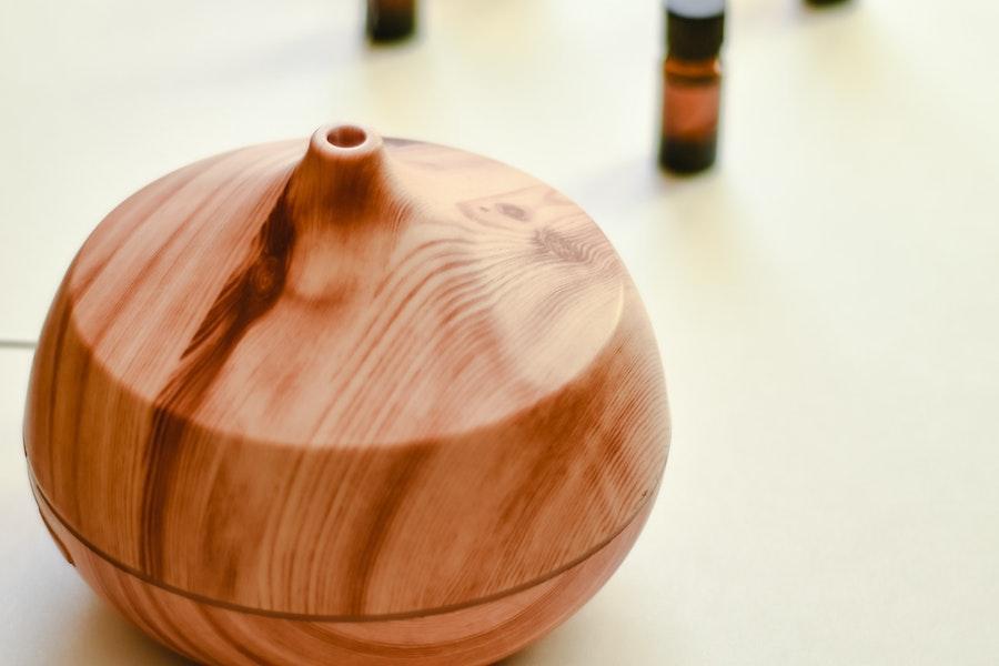 Water diffuser next to bottles of essential oil