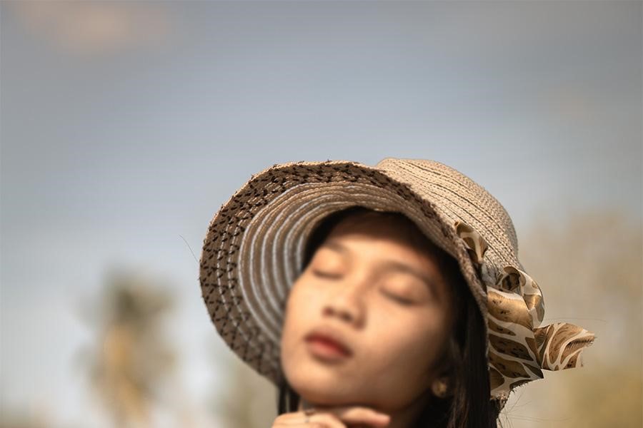 Wanita berpose dengan topi ember kaitan