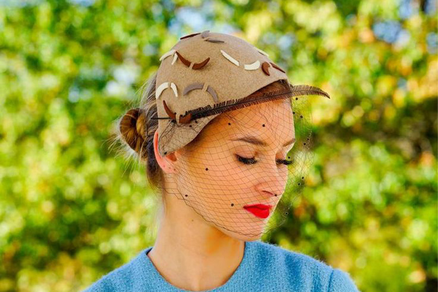 Woman wearing half-hat with net details