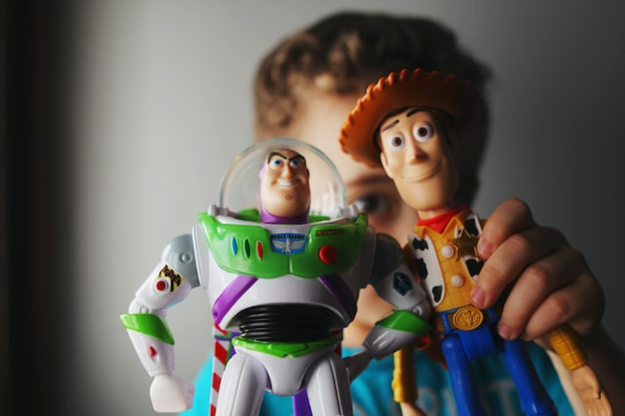 A child holding toys based on movie characters