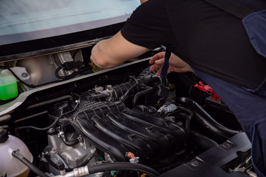 A mechanic fixing a water pump issue