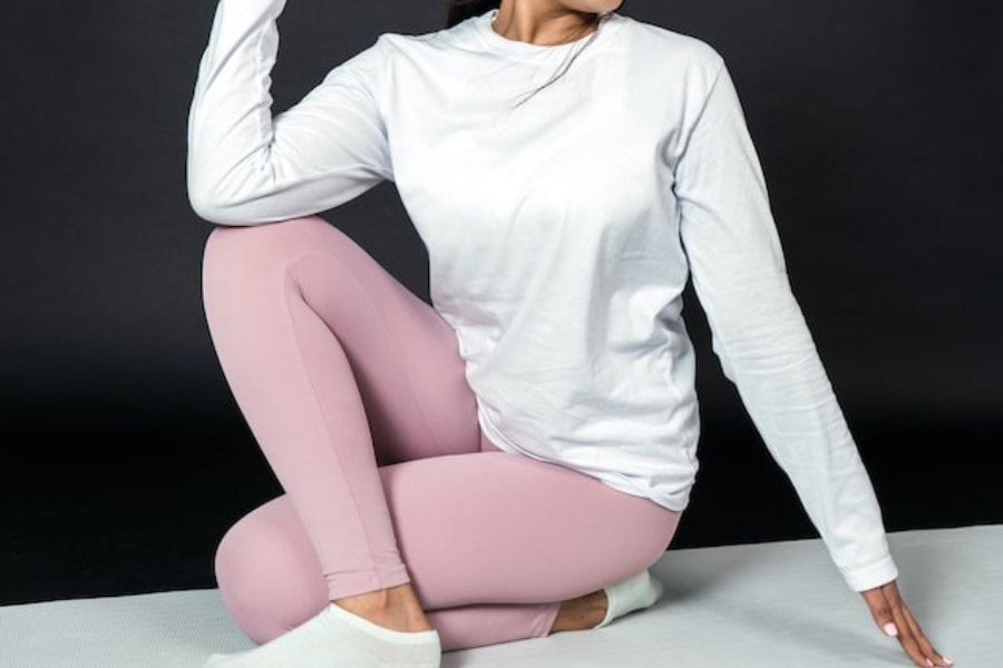 A woman wearing yoga socks stretching on a mat