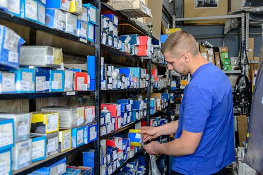 Individual inspecting stock in a warehouse