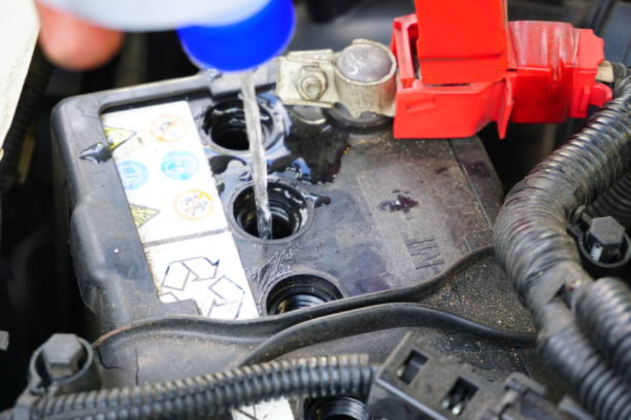 mechanic refilling battery acid