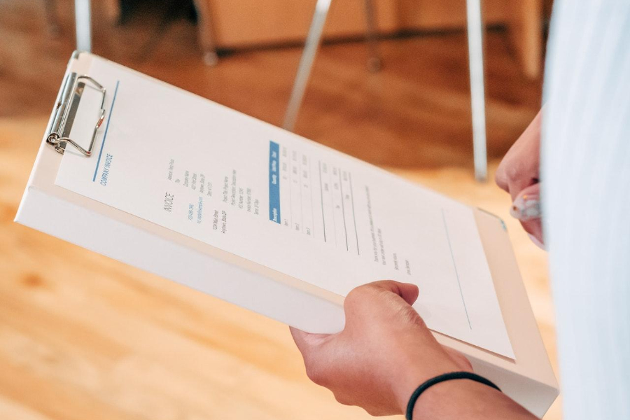 Person holding white printer paper