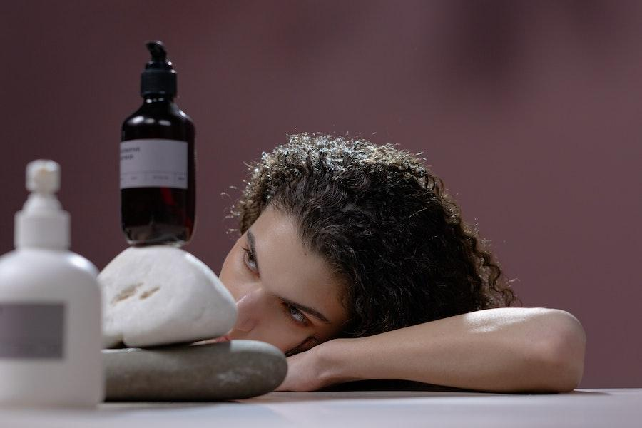 Woman looking at hair products for a beauty routine