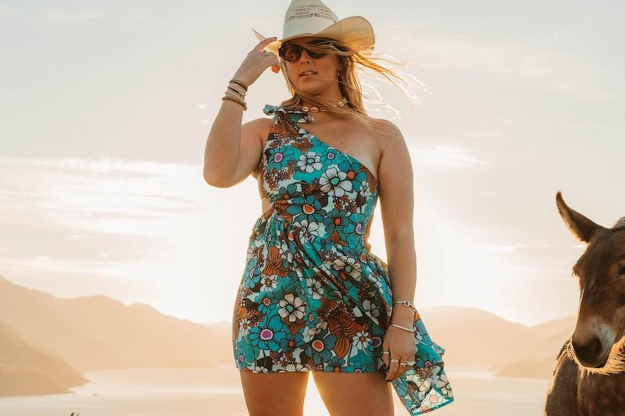 Woman posing with straw cowboy hat