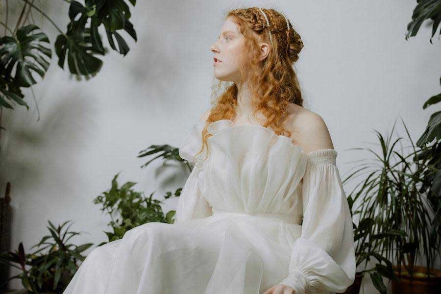 Mujer sentada con un elegante vestido blanco