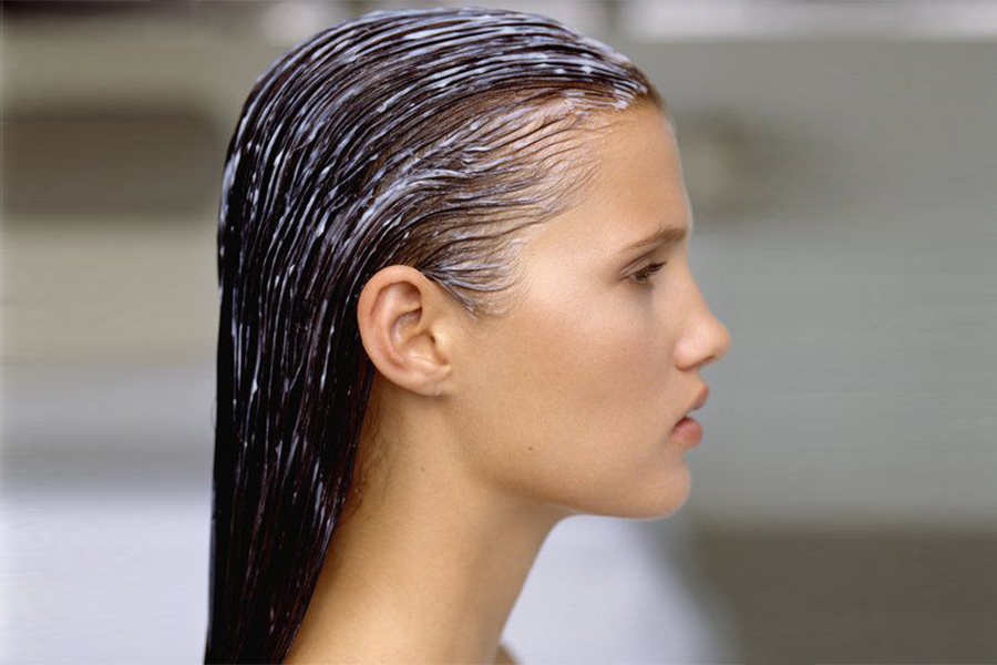 Woman with hair mask applied facing sideways