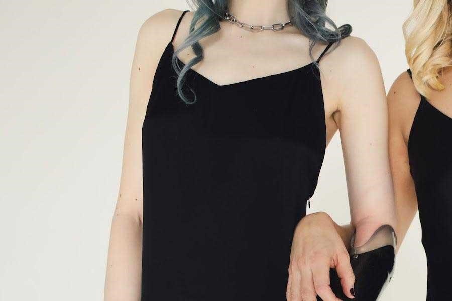 Women in black slip dresses