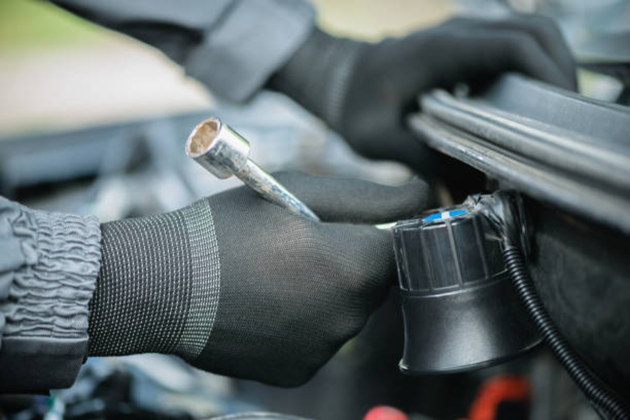 A mechanic installing a car alarm siren