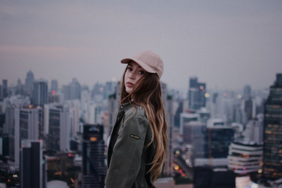 A Woman Wearing A Beige Baseball Cap