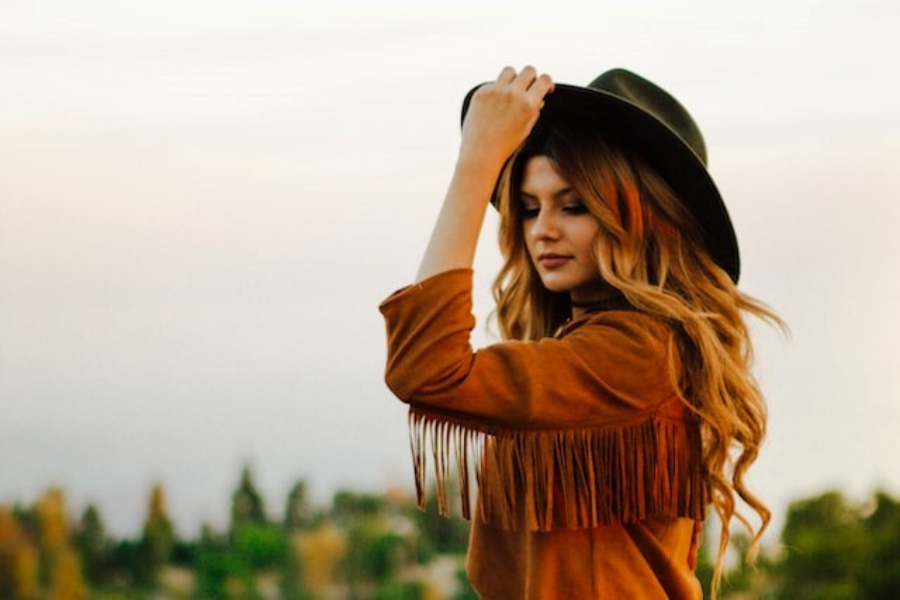 A woman wearing a black cowboy hat