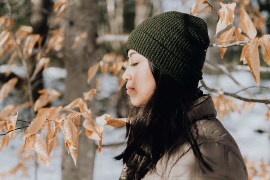 A Woman Wearing A Dark Green Knit Beanie Hat