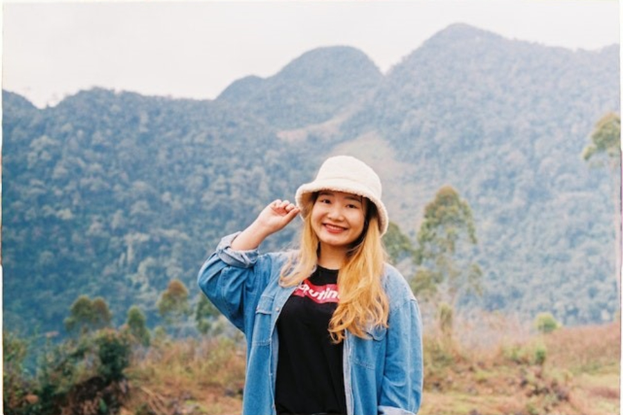 A Woman Wearing A Fuzzy Beige Bucket Hat