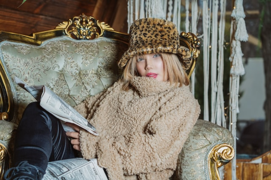 A woman wearing a leopard print fuzzy bucket hat